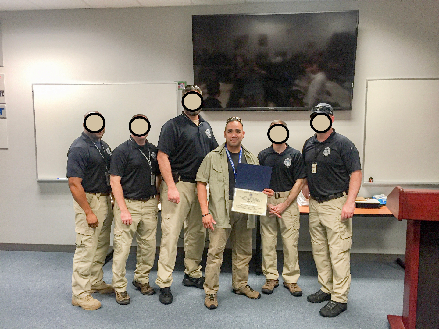 Credential presentation with a federal training cadre. Peers masked by request; work stays quiet.